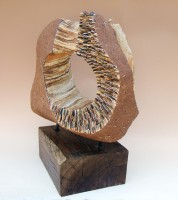 PUERTA DEL VIENTO (Wind gate) by Juan Ramon Gimeno - Ceramic Sculpture (2008)  Stoneware and porcelain colored with oxides or pigments.  Fired at 2300 ° F - 1260 ° C- cone 8 c.17.3/4” x 16.1/8” x 13” wood 9” x 12” x 5.1/8” total height: 22”  IFEJA Convention Center of Jaén, SPAIN